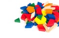 Multi Colored pattern blocks on a white wooden background.Isolate.