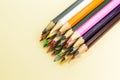 A lot of multi-colored pencils on a beige background Royalty Free Stock Photo