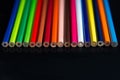 Multicolored pencils on a black background Royalty Free Stock Photo