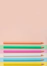 Multicolored pencils lined up on a multicolored background. Royalty Free Stock Photo