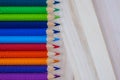 Multicolored pencils with water drops on wooden table Royalty Free Stock Photo
