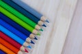 Multicolored pencils with water drops on wooden table Royalty Free Stock Photo