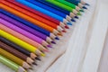 Multicolored pencils with water drops on wooden table Royalty Free Stock Photo