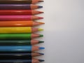 Multicolored pencils on a white paper