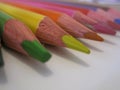 Multicolored pencils on a white paper