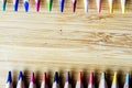 Multicolored pencils on wooden background forming a pattern with Royalty Free Stock Photo
