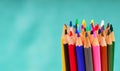 Multicolored pensils in the box on a blue background. Royalty Free Stock Photo