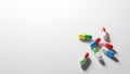 Multicolored pills on white background with plenty of negative space. Digital 3D render. Royalty Free Stock Photo