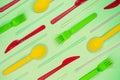 Multicolored plastic disposable forks, spoons. knives and straws on light blue background Royalty Free Stock Photo