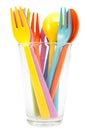 Multicolored plastic forks and spoons on glass Royalty Free Stock Photo