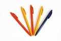 Multicolored plastic stationery pens on a white background Royalty Free Stock Photo