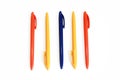 Multicolored plastic stationery pens on a white background Royalty Free Stock Photo