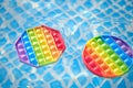 multicolored plastic toy pop it floats in the pool