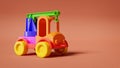 Multicolored plastic toy truck on orange background