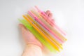 Multicolored plastic tubules in hand on white background Royalty Free Stock Photo