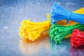 Multicolored plastic zip cable ties on metallic background const Royalty Free Stock Photo