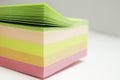Multicolored post it stickers stack on white background