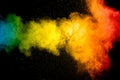 Multicolored powder explosion on black background.Colorful red yellow blue splash cloud on background Royalty Free Stock Photo