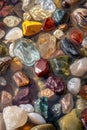Multicolored precious beautiful stones in water. Selective focus. Royalty Free Stock Photo