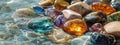 Multicolored precious beautiful stones in water. Selective focus. Royalty Free Stock Photo