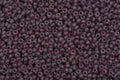 Multicolored purple seed beads background.