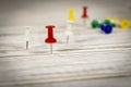 Multicolored push pins on the wooden table. Close up. Selective focus Royalty Free Stock Photo