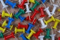 Multicolored push pins on a wooden table. Royalty Free Stock Photo