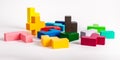 Multicolored puzzle toy elements. Chaos, disorder, work beginning concept. Wooden kids game for logical thinking Royalty Free Stock Photo