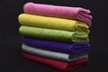 Multicolored rags in a pile. A bunch of colored towels. Terry towels. A cleaning cloth