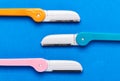 Multicolored razor shavers. Colored razors shavers, on a blue background. copy space for text. View from above Royalty Free Stock Photo