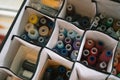 Multicolored reels of sewing threads in box with compartments Royalty Free Stock Photo