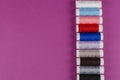 Multicolored Reels of Thread on a Purple Background Royalty Free Stock Photo