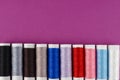 Multicolored Reels of Thread on a Purple Background Royalty Free Stock Photo