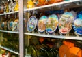 Multicolored relief plates on shelves of Georgian souvenir shop