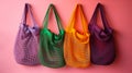 Multicolored reusable shopping bags on pink background. Zero waste concept.