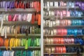 Multicolored ribbons for sewing on the shelf