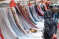 Multicolored rolls of fabrics and textiles on the market. Sale of textiles on Turkish market in Berlin