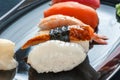Multicolored rolls and sushi rice, caviar and salmon, eel, trout on the table in the background. Royalty Free Stock Photo