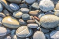 Multicolored round stones on the beach. Near the sea and sand