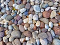 Multicolored round stones pebbles background