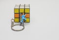 Multicolored Rubik`s cube and miniature workers