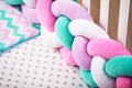 Multicolored scoop, soft fence in children `s empty crib white. cozy crib Royalty Free Stock Photo