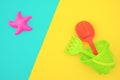 Multicolored set children`s toys for summer games in sandbox or on sandy beach on blue yellow background with copy space. Top vie Royalty Free Stock Photo