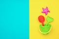 Multicolored set children`s toys for summer games in sandbox or on sandy beach on blue yellow background with copy space. Top vie Royalty Free Stock Photo