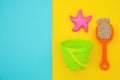 Multicolored set children`s toys for summer games in sandbox or on sandy beach on blue yellow background with copy space. Top vie Royalty Free Stock Photo