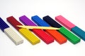 Multicolored set of plasticine sticks and sculptural knife on white background