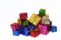 Multicolored shiny boxes with gifts lie on a white background. Big and small. Holiday Sale & Foil Packaging