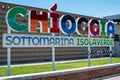 Multicolored sign welcoming tourists to the beaches of Sottomarina near Venice, with the words: Chioggia, Sottomarina, Isolaverde