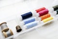 Multicolored skeins of thread in the set. Threads and a thimble in a plastic box Royalty Free Stock Photo