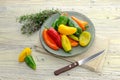 Multicolored, small peppers on a plate